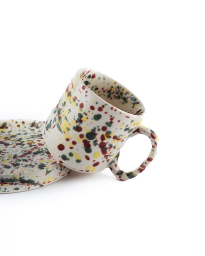 coffee mug and saucer with splatter