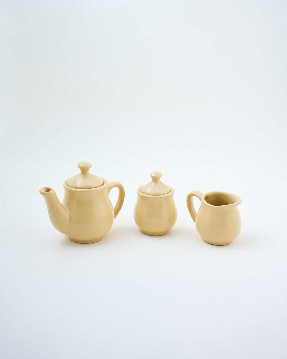 miniature tea kettle and ceramic pitcher